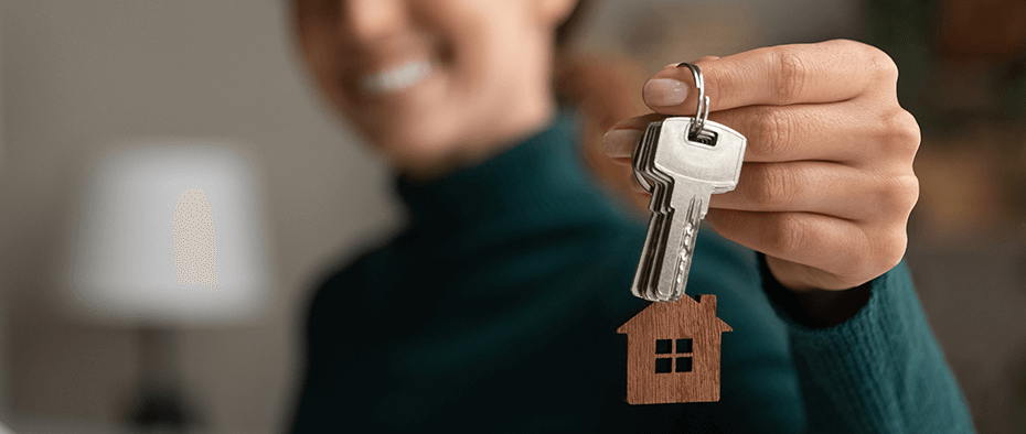 first home builder holding keys and smiling