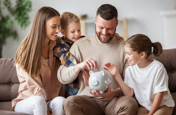 First home buyers putting savings into a piggy bank